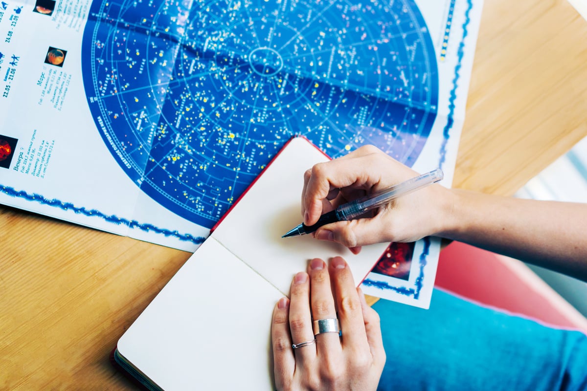 Woman Writing Notes with Pencil and Star Chart